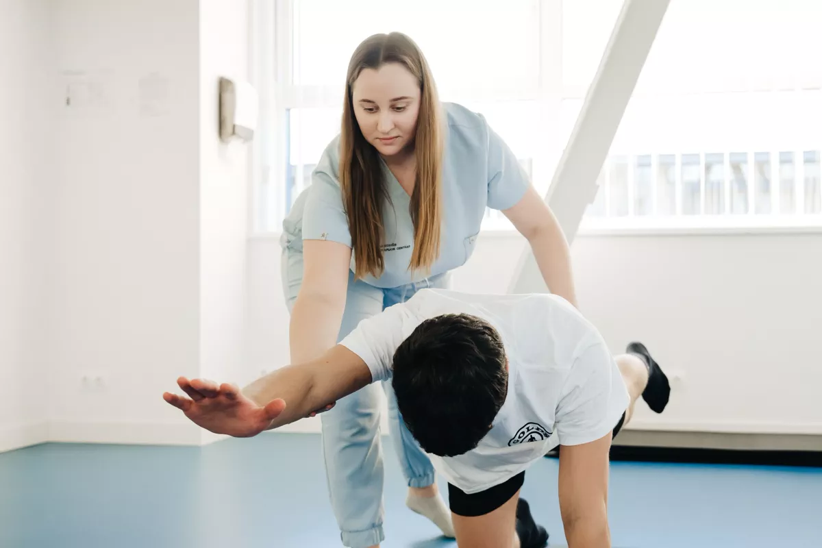 Physiotherapist assisting a participant with a mobility exercise